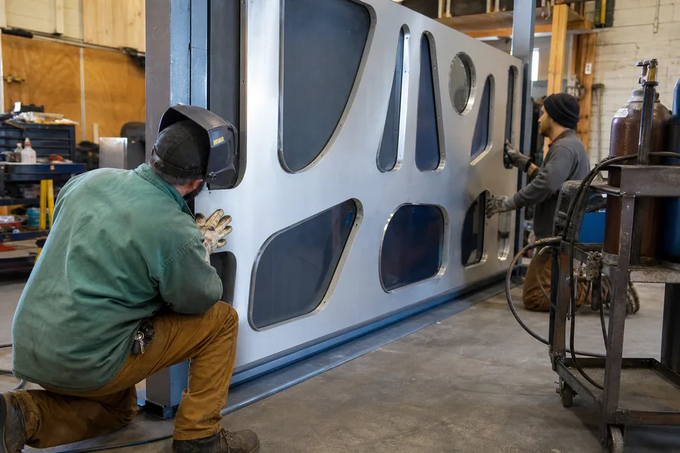 Routed aluminum monument sign face being fitted on the shop floor